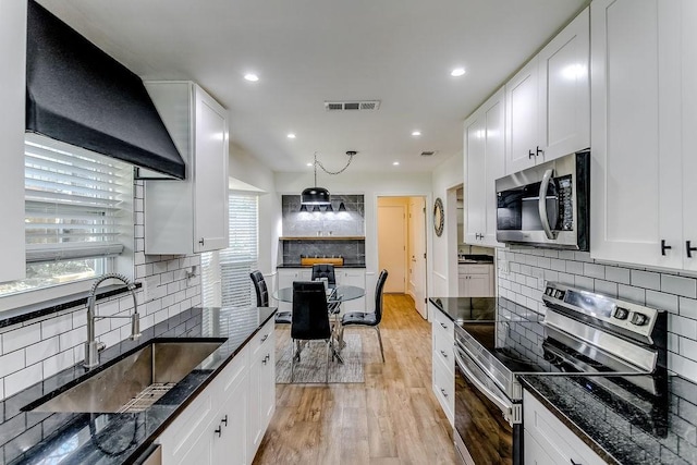 kitchen with white cabinets, appliances with stainless steel finishes, and sink