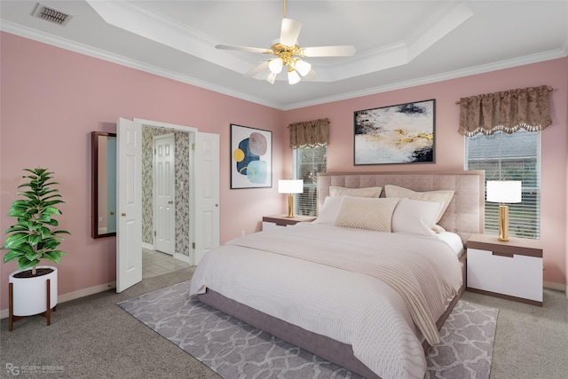 bedroom featuring ceiling fan, light carpet, ornamental molding, and a raised ceiling