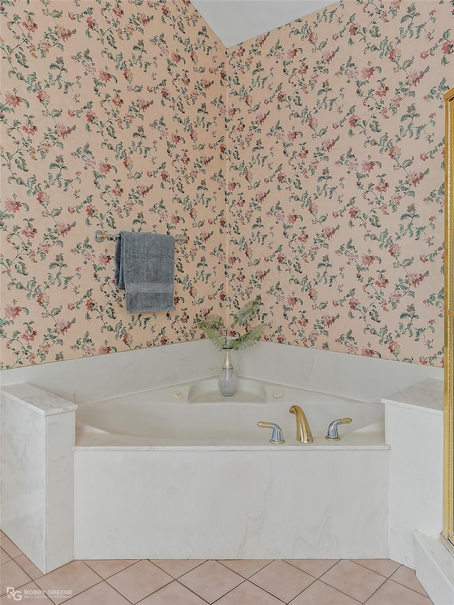 bathroom with a bathtub and tile patterned flooring