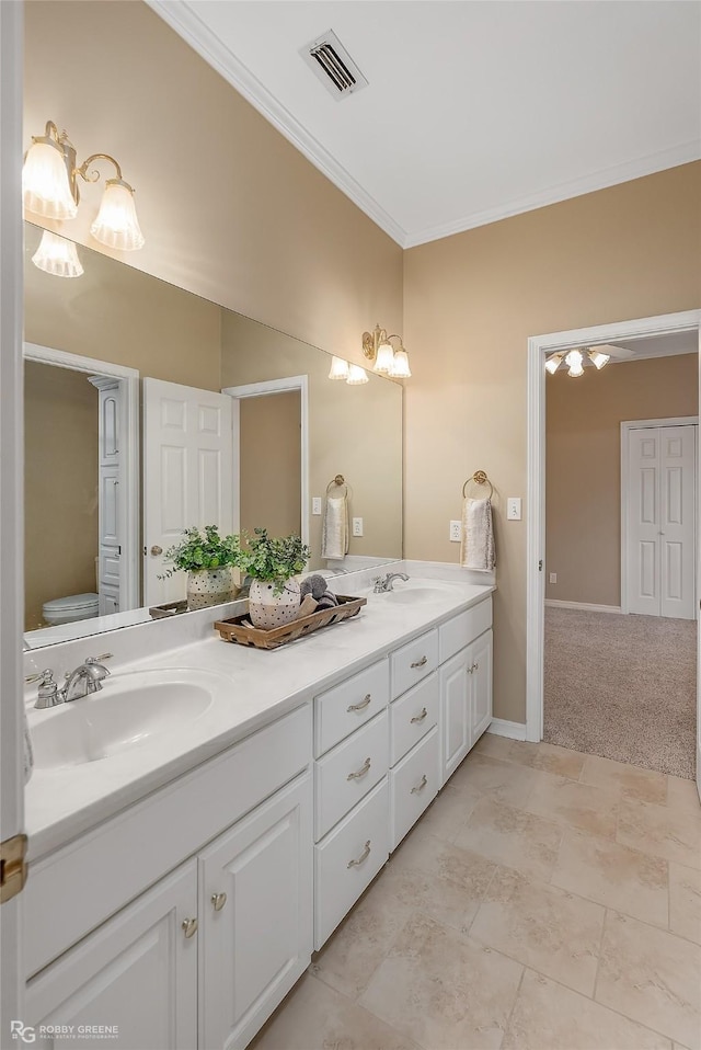 bathroom with vanity and crown molding