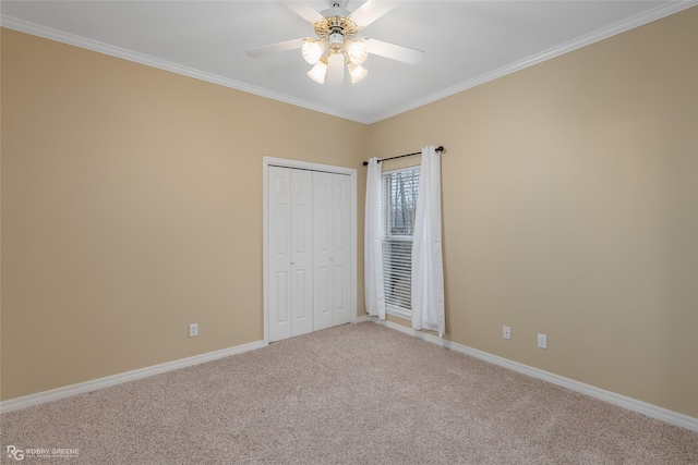 unfurnished bedroom with ceiling fan, carpet, a closet, and ornamental molding