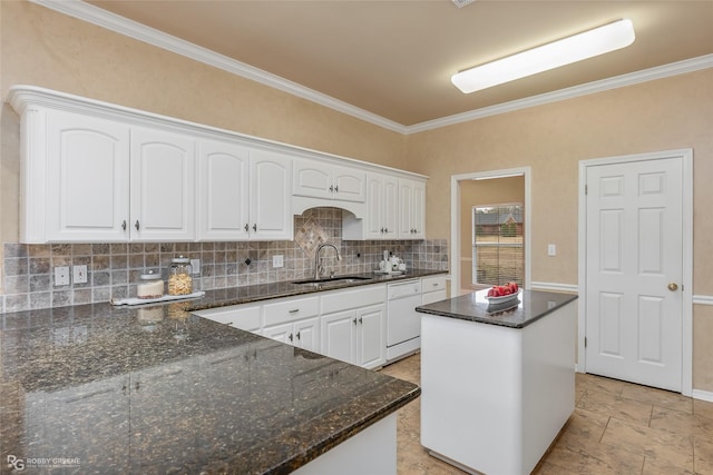 kitchen with white cabinetry, dark stone countertops, a center island, and sink