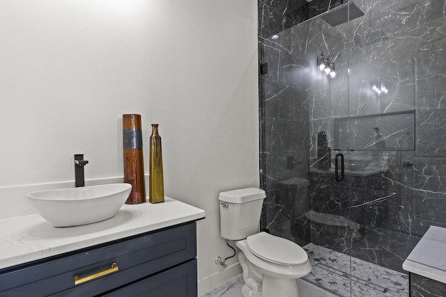 bathroom featuring a shower with shower door, vanity, and toilet