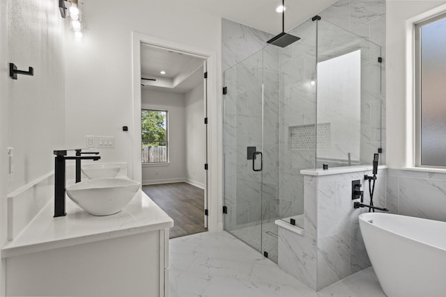 bathroom featuring vanity and shower with separate bathtub