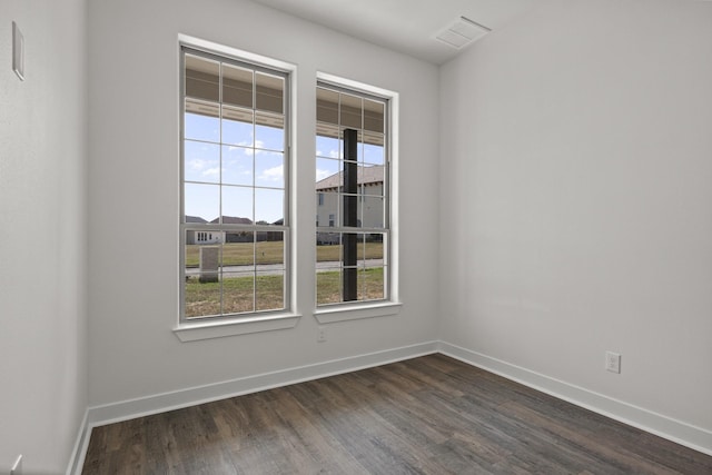 empty room with dark hardwood / wood-style flooring