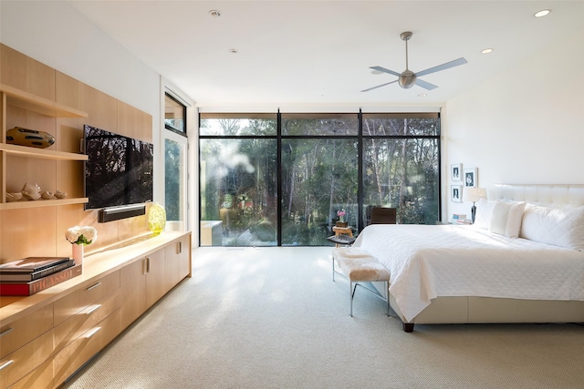 bedroom featuring ceiling fan and floor to ceiling windows