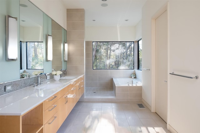 bathroom with tile patterned flooring, shower with separate bathtub, and vanity