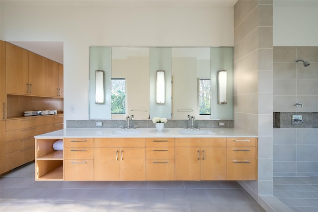 bathroom with a shower, decorative backsplash, tile patterned floors, and vanity