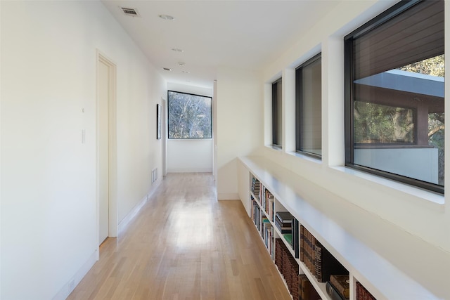 corridor with light hardwood / wood-style flooring