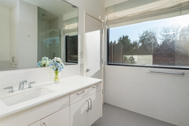 bathroom with vanity, tile walls, backsplash, and tile patterned floors