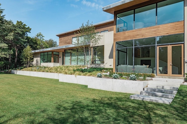 rear view of property featuring a yard