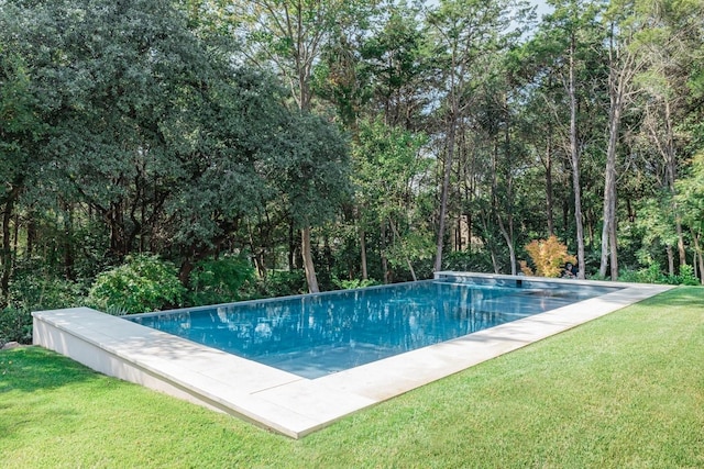 view of pool featuring a yard