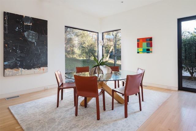 dining area featuring a wealth of natural light and light hardwood / wood-style floors