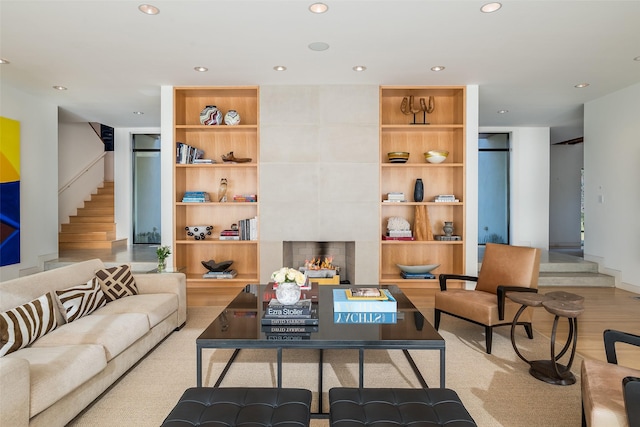 living room featuring a fireplace and built in shelves