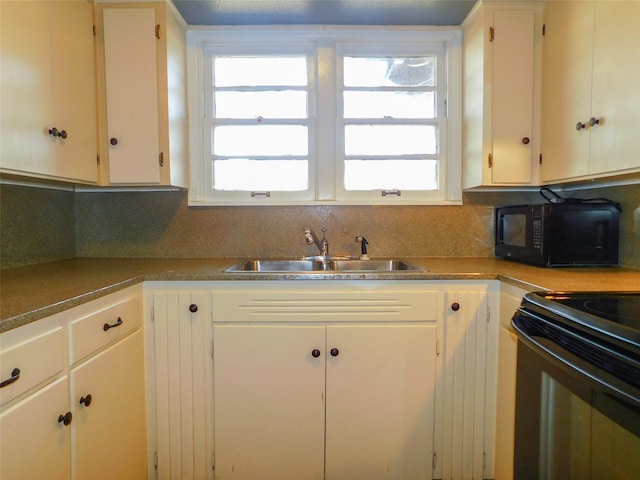 kitchen featuring black appliances, white cabinets, decorative backsplash, and sink