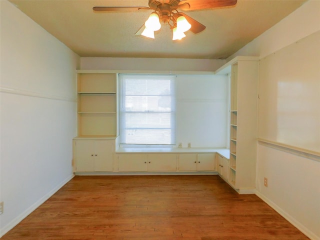 empty room featuring ceiling fan and light hardwood / wood-style flooring