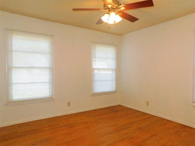 unfurnished room with ceiling fan, plenty of natural light, and light wood-type flooring