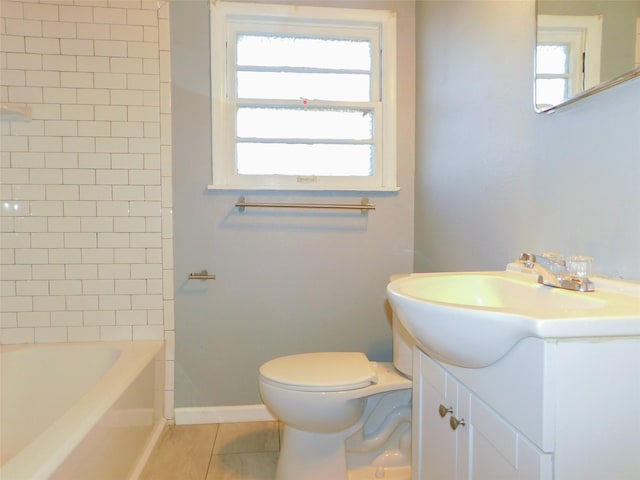 full bathroom with toilet, tile patterned flooring, tiled shower / bath combo, and vanity