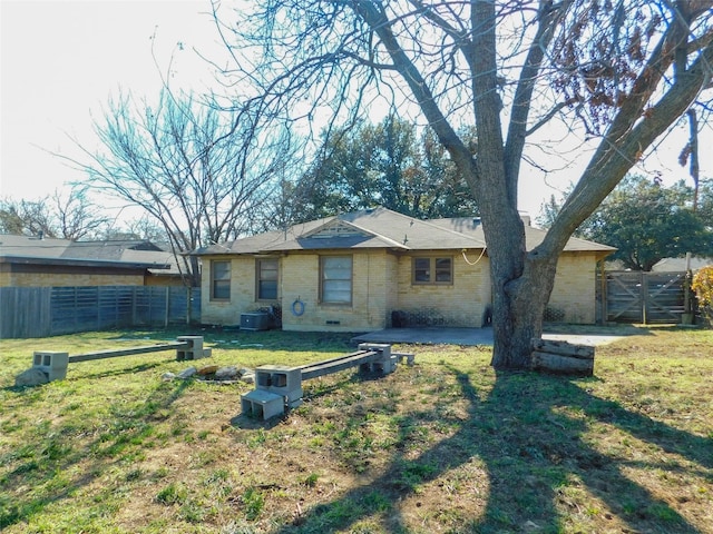 view of front of home featuring central AC, a patio, and a front yard