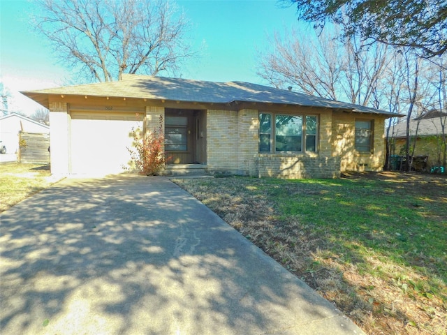 ranch-style home with a front yard and a garage