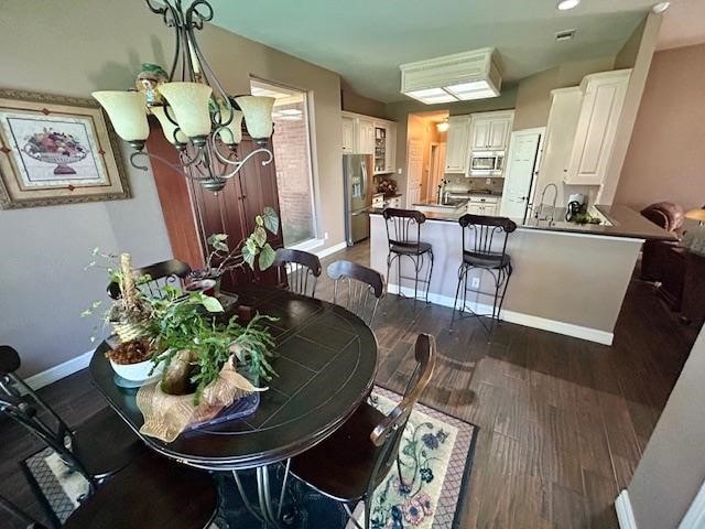 dining space featuring dark wood-type flooring