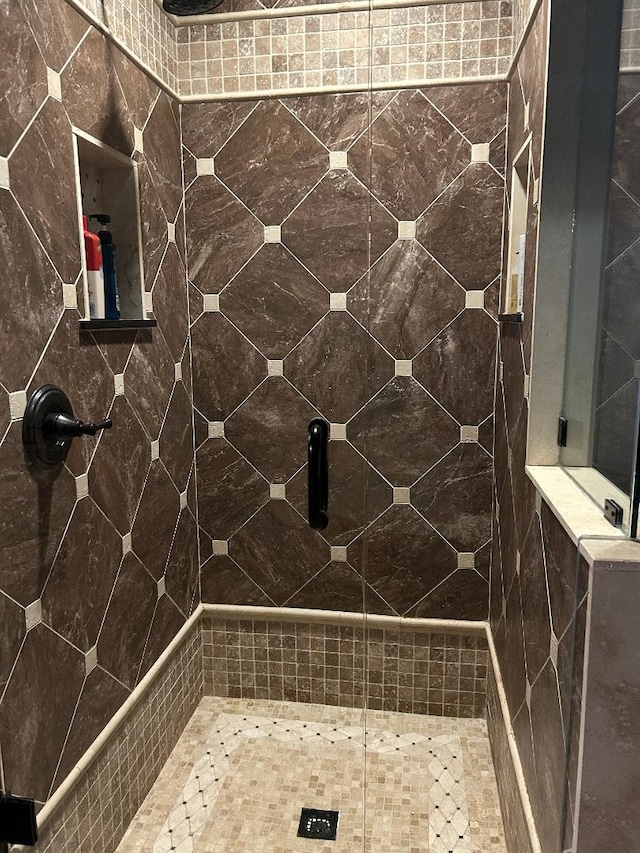 bathroom with tiled shower