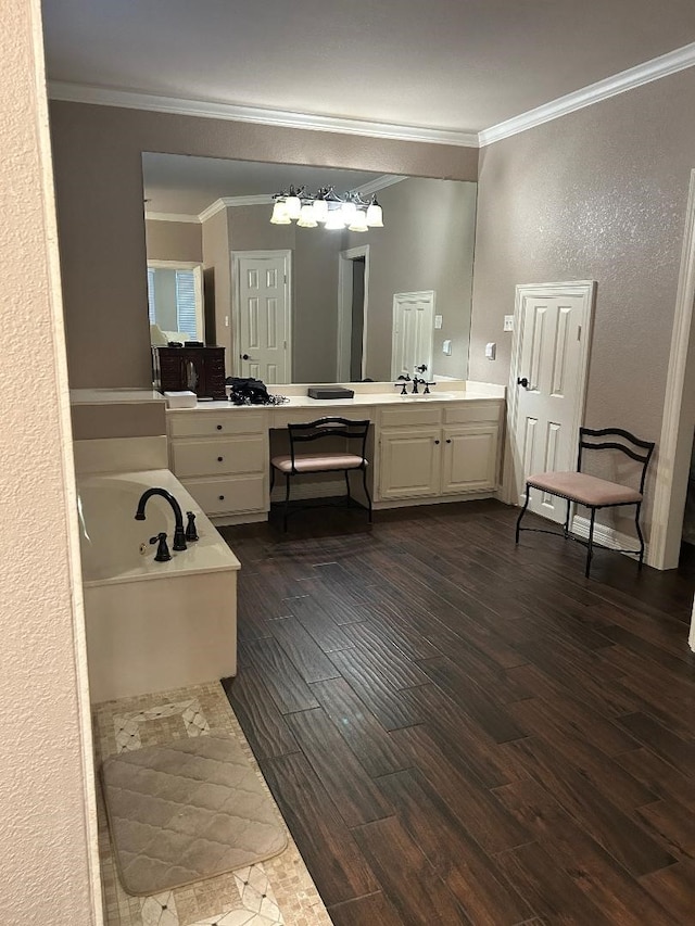 bathroom with vanity, wood-type flooring, crown molding, and a bath