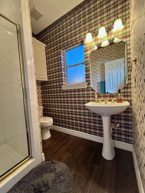 bathroom with walk in shower and toilet