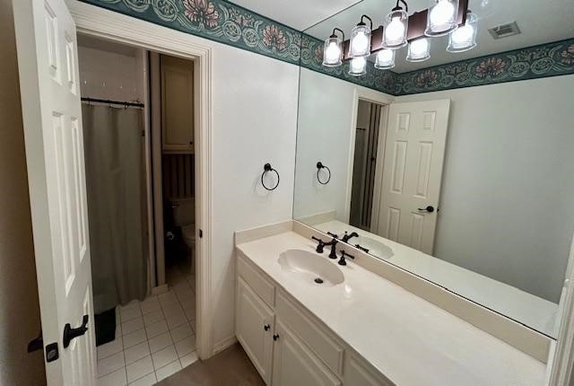 bathroom featuring vanity, toilet, and tile patterned flooring