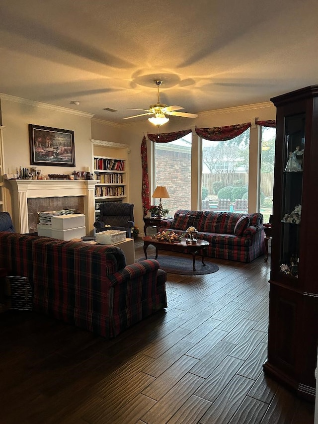 living room featuring ceiling fan, dark hardwood / wood-style floors, and crown molding