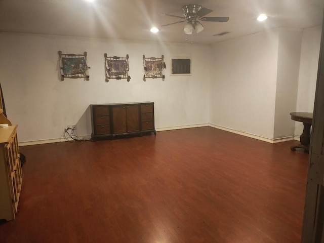 interior space with ceiling fan and dark wood-type flooring