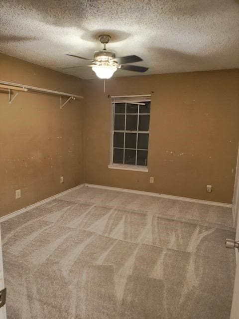 carpeted empty room with a textured ceiling