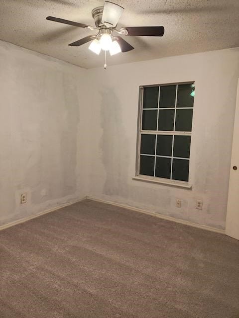 carpeted empty room featuring ceiling fan and a textured ceiling