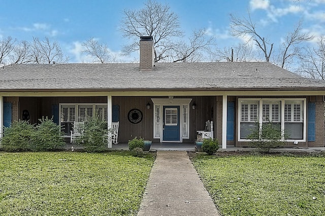 ranch-style home featuring a porch and a front yard