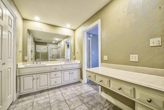 bathroom with vanity, tile patterned flooring, and a shower with door