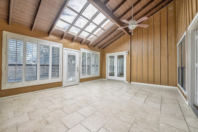 unfurnished sunroom featuring ceiling fan, wooden ceiling, and vaulted ceiling with skylight