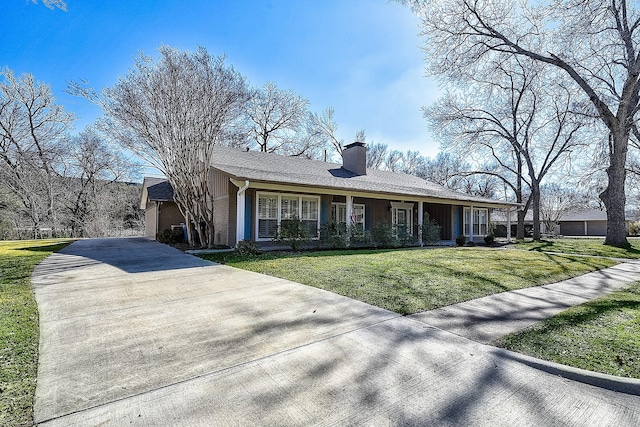 ranch-style house with covered porch and a front lawn