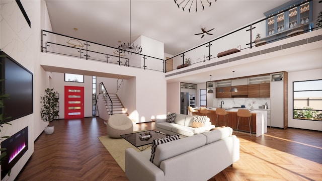 living room with stairs and a high ceiling