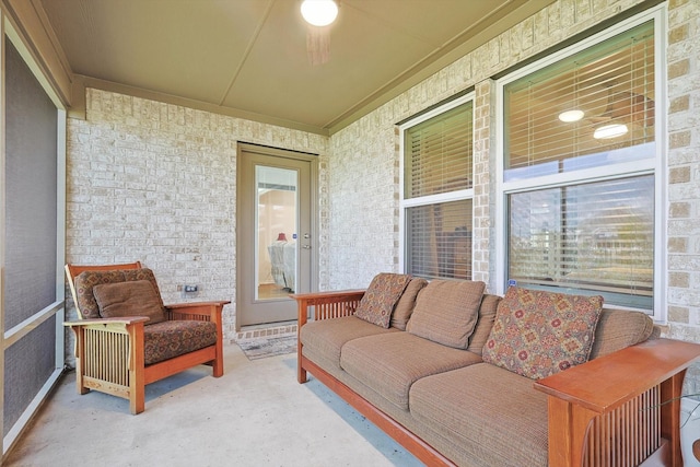 sunroom featuring ceiling fan