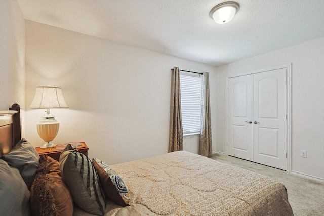 bedroom with light colored carpet and a closet