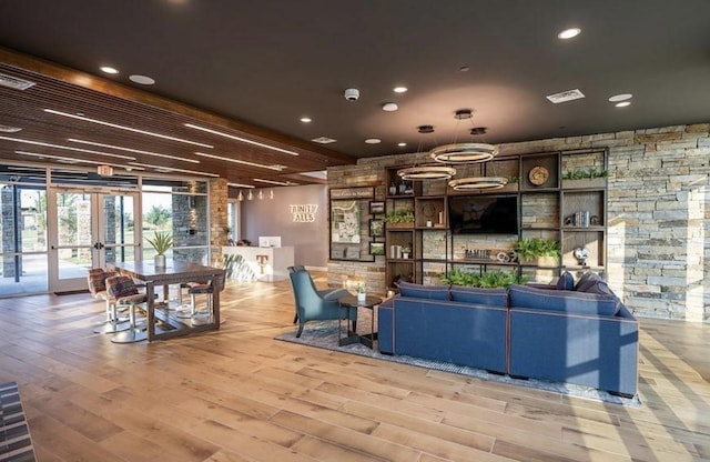 living room featuring french doors and light hardwood / wood-style flooring