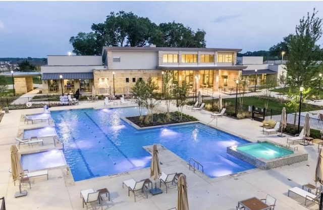 view of swimming pool featuring a patio area, a hot tub, and pool water feature