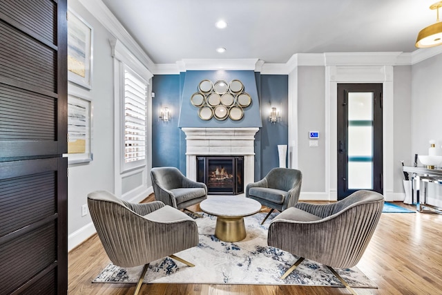 living room with light hardwood / wood-style floors and ornamental molding