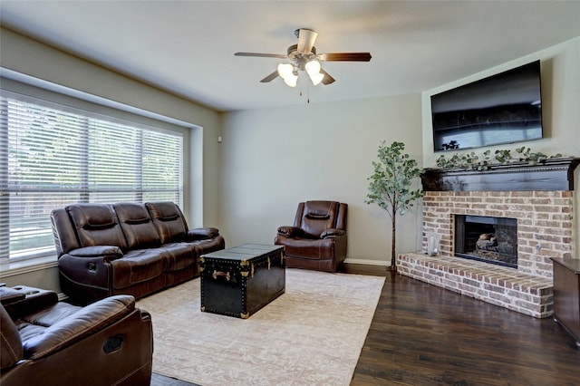 living room featuring ceiling fan, a brick fireplace, and hardwood / wood-style flooring