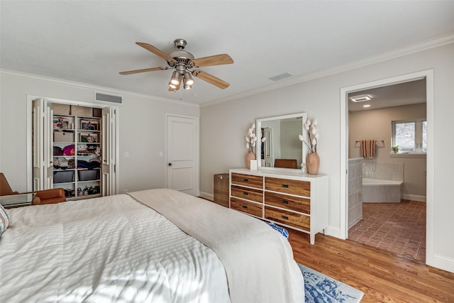 bedroom featuring ceiling fan, a closet, crown molding, and ensuite bathroom