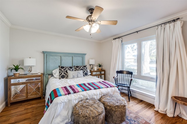 bedroom with ceiling fan, crown molding, and hardwood / wood-style flooring