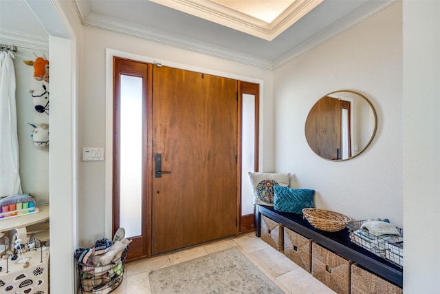 tiled foyer featuring ornamental molding