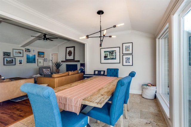 dining room with ceiling fan with notable chandelier, ornamental molding, and lofted ceiling