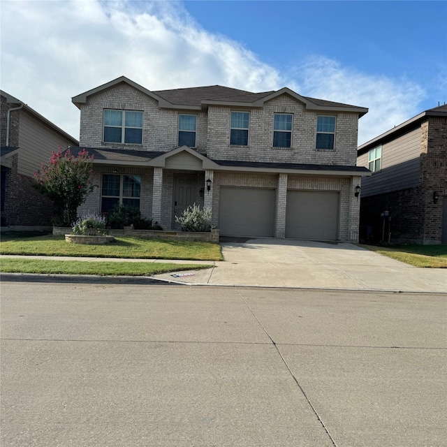 view of front of home featuring a garage and a front lawn