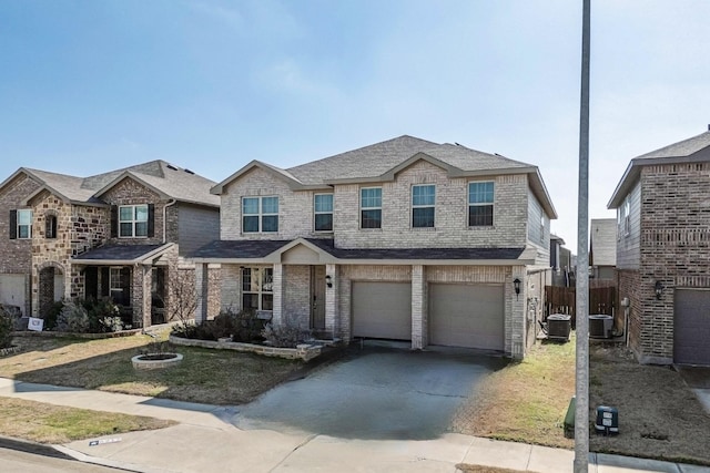 6217 Jackstaff Dr, Fort Worth, TX 76179 - view of front of house with driveway, a garage, cooling unit, and brick siding